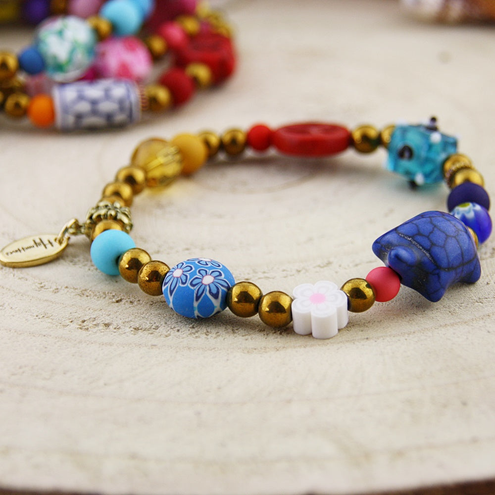 Fantasie armband in goud en blauw tinten