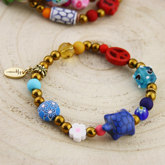 Fantasie armband in goud en blauw tinten