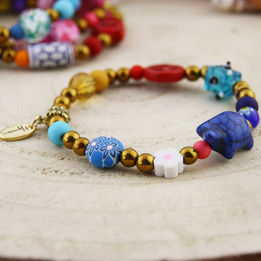 Fantasie armband in goud en blauw tinten
